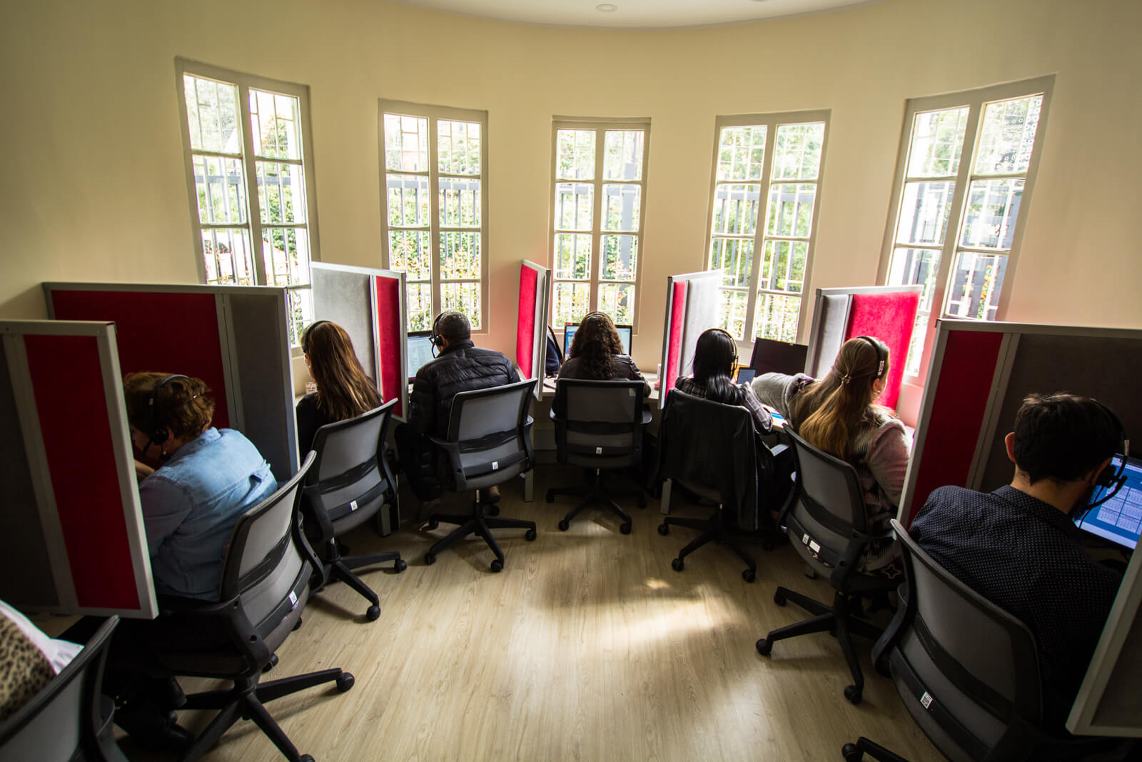 Personas en oficina atendiendo llamadas y trabajando